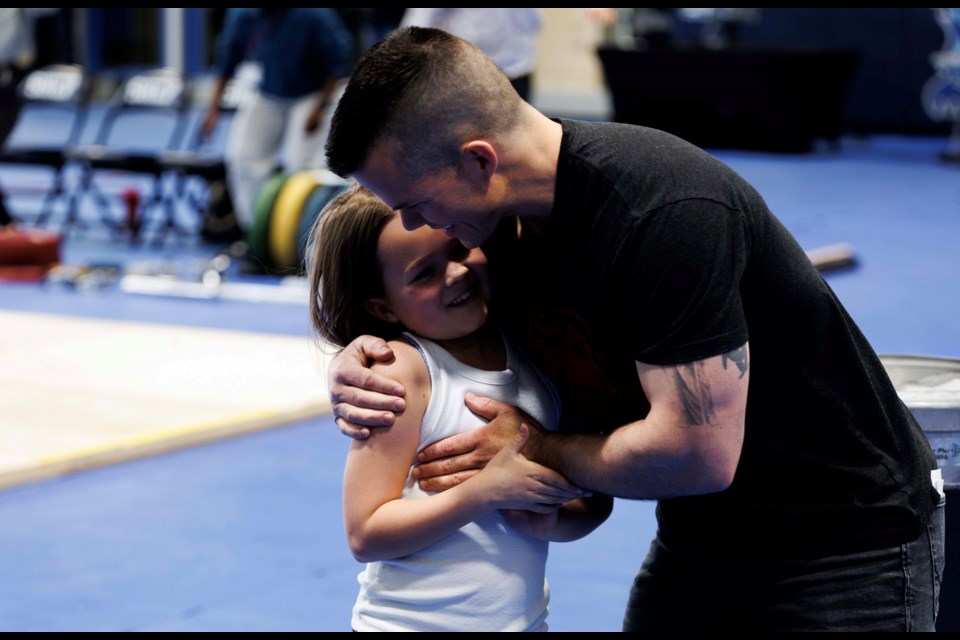 Arya Schultz celebrates with her dad Dan Schultz. The duo share a passion for lifting.  Joel Kingston/ PHOTO