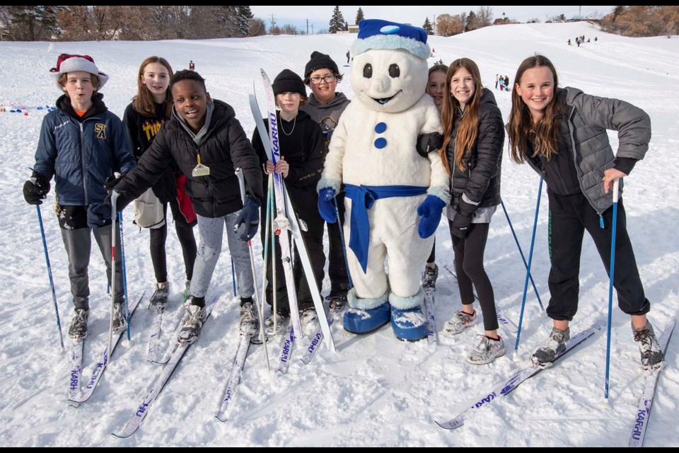 Ecole Father Jan students try out cross-country skiing with some advice from Bonhomme.