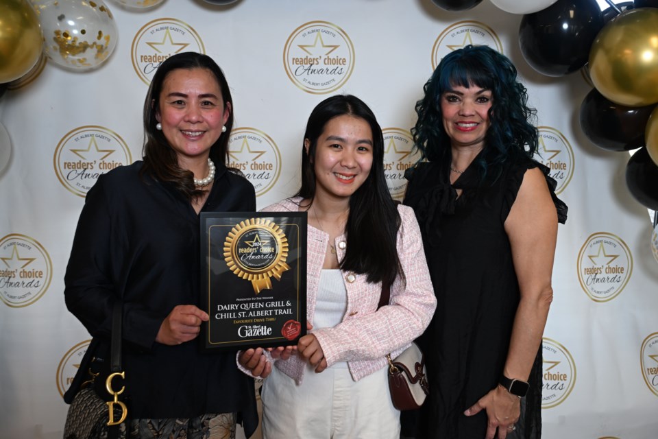 Pinky Vidal along with Noime Manlulu from DQ Grill pose for a photo with St. Albert Gazette Sales Manager Angie Hampshire.