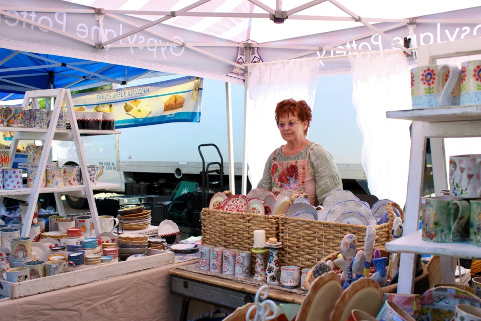 Linette Schurko, owner and artist behind Gypsy Jane Pottery. She is surrounded by her pottery that she sells at the St. Albert Farmers' Market.