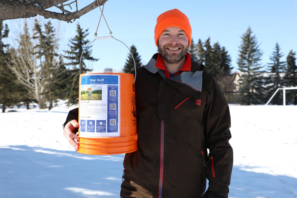 Lacombe Park resident, Nick Legault, shows off his disc golf skills next to one of his temporary disc-golf holes het set up in Langholm Park. City council voted to create a more formal temporary disc golf course at the park this summer. JESSICA NELSON/St. Albert Gazette
