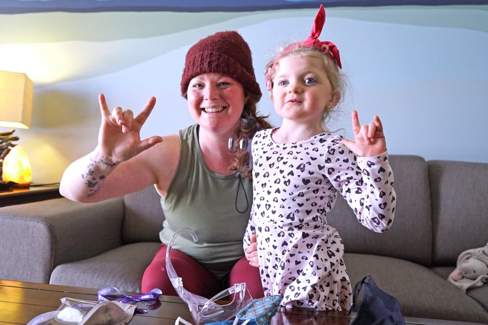 Louise Berezowsky and her five-year-old daughter Clara signing 'I love you' at their home in St. Albert. Clara lives with CHARGE syndrome, a rare genetic syndrome seen in 1 in 10,000 births. BRITTANY GERVAIS/St. Albert Gazette