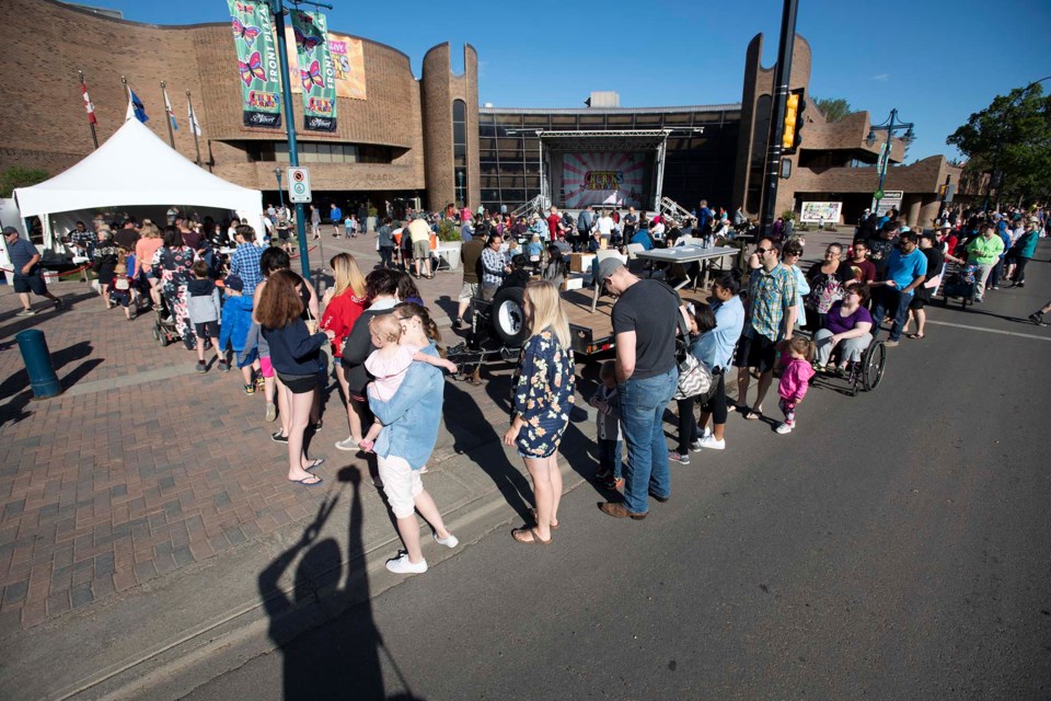 Hundreds of hungry parade goers waited in line to munch on pancakes and sausages during the annual St. Albert Gazette pancake breakfast in front of St. Albert Place prior to the Rainmaker Rodeo Parade May 26, 2018. 