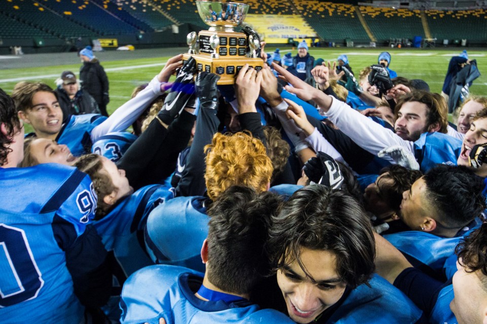 RAISING THE CUP – The Paul Kane Blues celebrate their division two Miles conference championship victory in metro Edmonton high school football after beating the Leduc Tigers 45-14 Friday at Commonwealth Stadium. Paul Kane is 8-0 entering the Tier II provincial north semifinal against the defending Alberta Bowl champion Lloydminster Barons on Saturday in the Border City.
CHRIS COLBOURNE/St. Albert Gazette