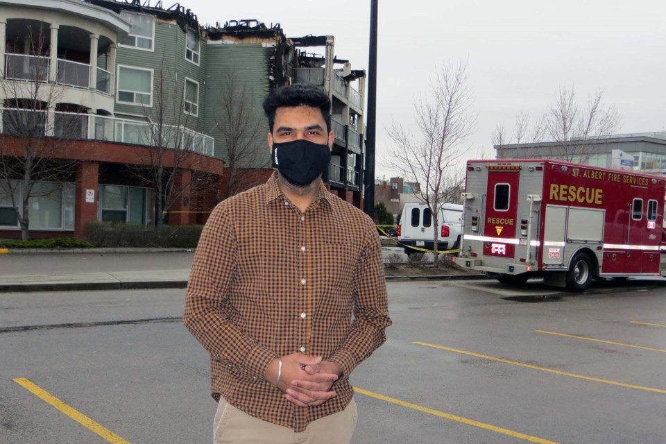 Gurdeep Singh, manager at Olympia Liquor, stands in front of Citadel Mews West assessing the fire's damage and gratful none of his customers were harmed. 