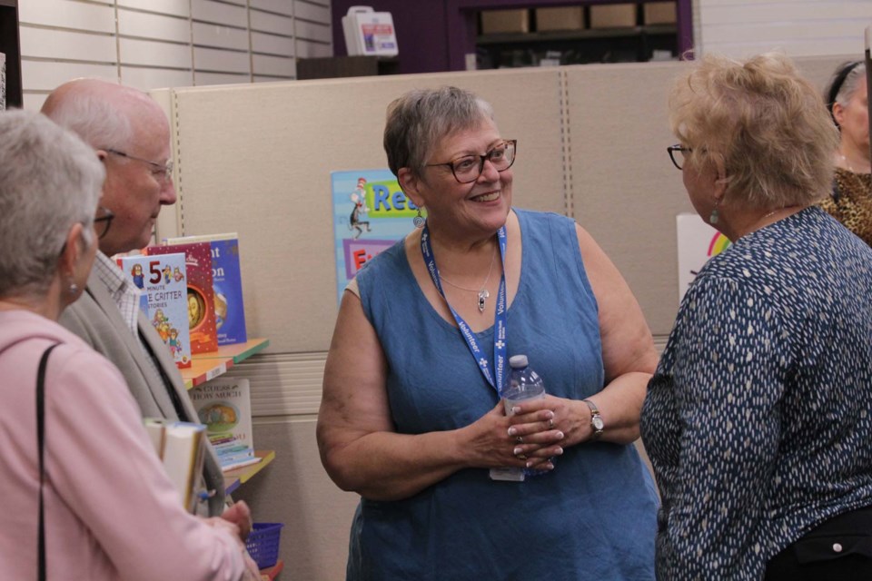  SHAVA president Jocelyne Durocher (centre), chats with some of the first customers through the door at SHAVA's new bookstore in St. Albert Centre during the grand opening on Tuesday morning, Sept. 6, 2022. JACK FARRELL/St. Albert Gazette