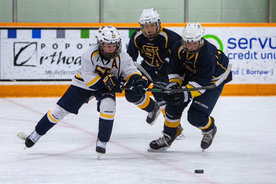 STRIKE FORCE – Assistant captain Ty Meunier of the St. Albert Sabres and Matthew Lenz of the St. Albert Saints attack the puck ahead of Ashton Johnson of the Saints in the Hockey Edmonton peewee AA game Tuesday at Mark Messier Arena. The Sabres (9-10-2) won 5-3. It was the second-last league game for the Saints (15-6-4) before competing at the 61st annual Quebec International Peewee Tournament in Quebec City as the St. Albert  Jr. Oilers.
CHRIS COLBOURNE/St. Albert Gazette