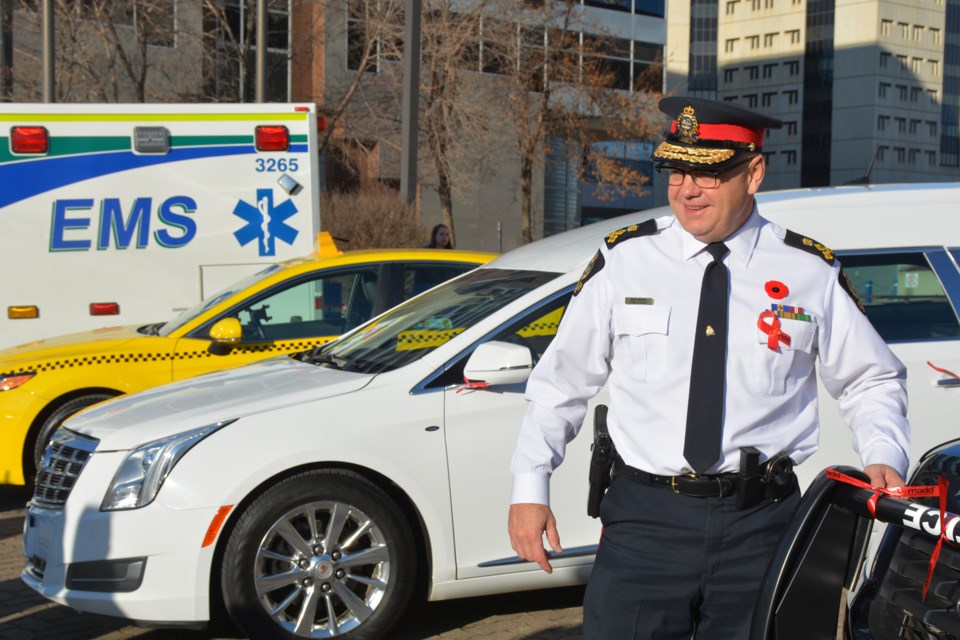 Edmonton Police Chief Dale McFee ties a red MADD ribbon to a police cruiser, reminding all drivers to choose the right ride after a night of drinking. SCOTT HAYES/Photo