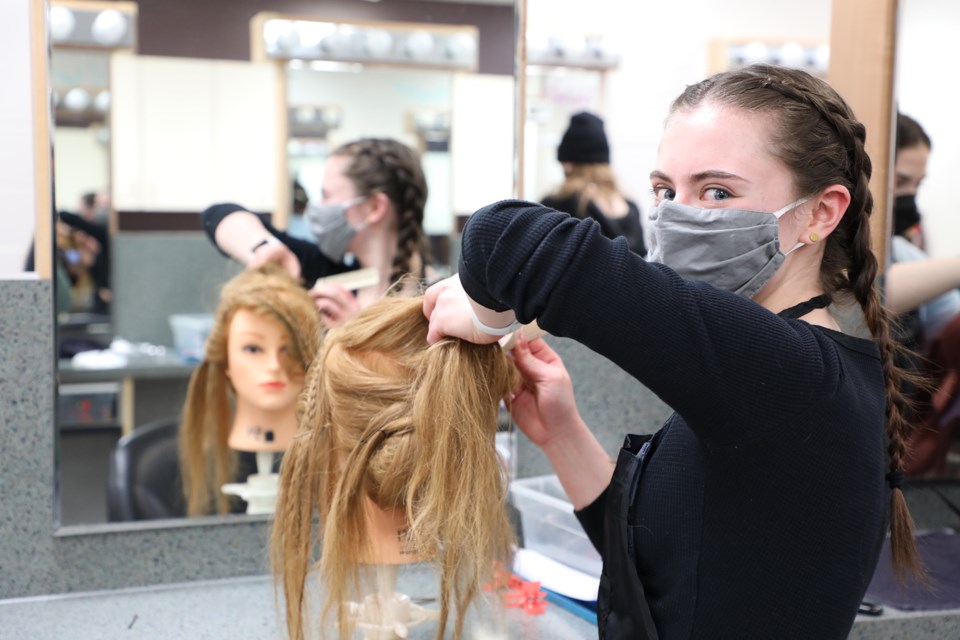 Sarah Shipka practises her wedding hair styling skills at Paul Kane High School Monday in preparation for Skills Canada Alberta Hairstyling regional competition.