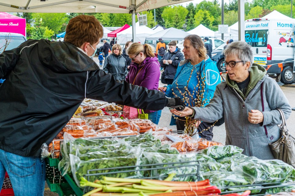 Despite the rain and cooler temperatures, shoppers were eager to attend the opening day of the annual St. Albert Farmers' Market on Saturday at its new location at Servus Credit Union Place. CHRIS COLBOURNE/St. Albert Gazette