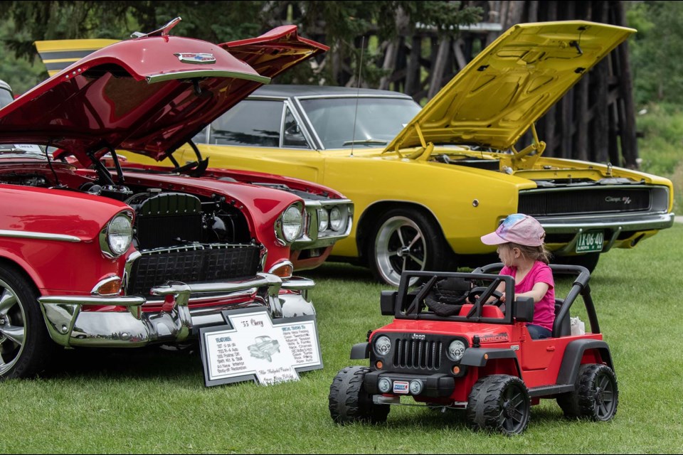 7 year old Alessandra Briceno checks out the classic cars in her little motorized Jeep at the Rock'n August Show and Shine in St Albert JOHN LUCAS/St. Albert Gazette