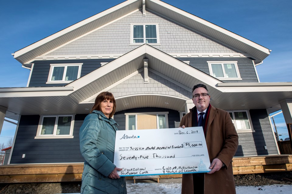 Dale Nally, right, UCP MLA for Morinville-St. Albert, presents a cheque to Lynne Rosychuk, president of the Jessica Martel Memorial Foundation, at the new safe house still under construction in Morinville December 6, 2019.   DAN RIEDLHUBER/St. Albert Gazette