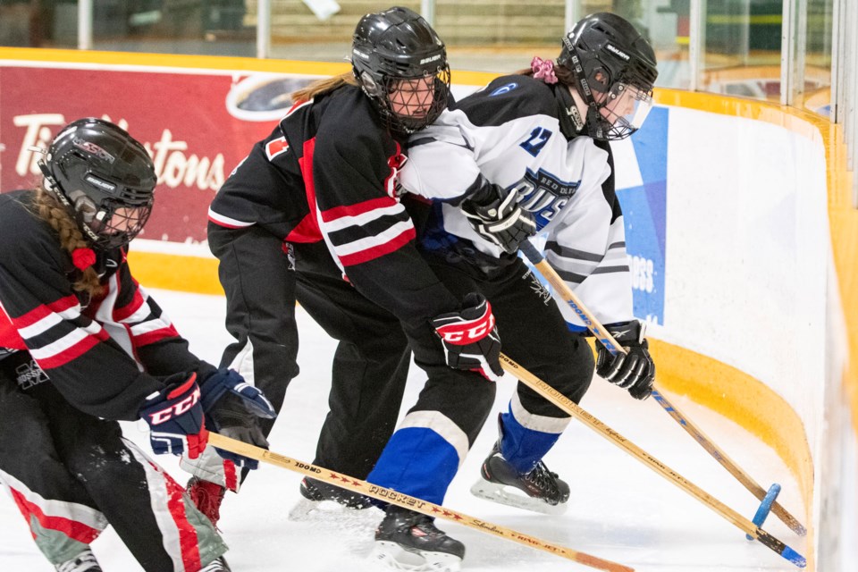 TRAPPED – Grace Debogorski of the Red Deer Rush is cornered by Tayte Arlinghaus, left, and Eve Starchuk of the St. Albert Mission in Saturday's U14AA Black Gold League game. The Mission won 4-0 at Mark Messier Arena. The Mission are 25-11-3-2 overall after Sunday's 10-3 decision against the Edmonton Elite at Go Auto Arena. The Ringette Alberta AA championships start Feb. 28 in Spruce Grove and four U14AA teams qualify for westerns in March at Prince George, B.C. 
BRUCE EDWARDS/St. Albert Gazette