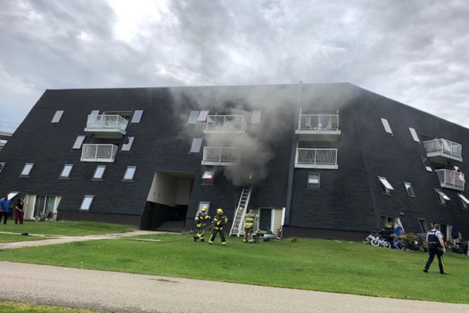 Firefighters on scene Friday afternoon at a blaze on Rivercrest Crescent. CAROLYN MARTINDALE/Photo