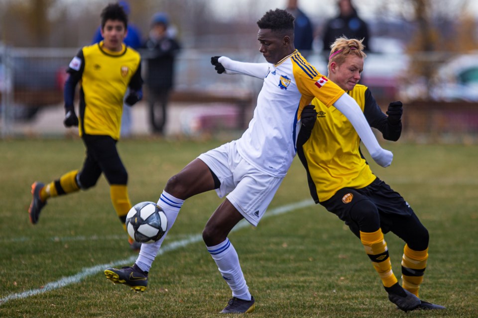 CONTROLLING THE SITUATION – Dieu-Merci Michel of the St. Albert Impact plays the ball in tight coverage in Wednesday's match against Halifax County United SC at the U15 National Cup. The first of two goals by Michel against the Nova Scotia team opened the scoring in the fifth minute of the 7-0 win at Ivor Dent Sports Park. Friday the Impact played PEI FC in the last group B match in the  qualification phase of the 12-team tournament and the score was unavailable at press time. Depending on the result, today's quarter-final match for the Alberta champions starts at 3:30 or 4:30 p.m.
CHRIS COLBOURNE/St. Albert Gazette