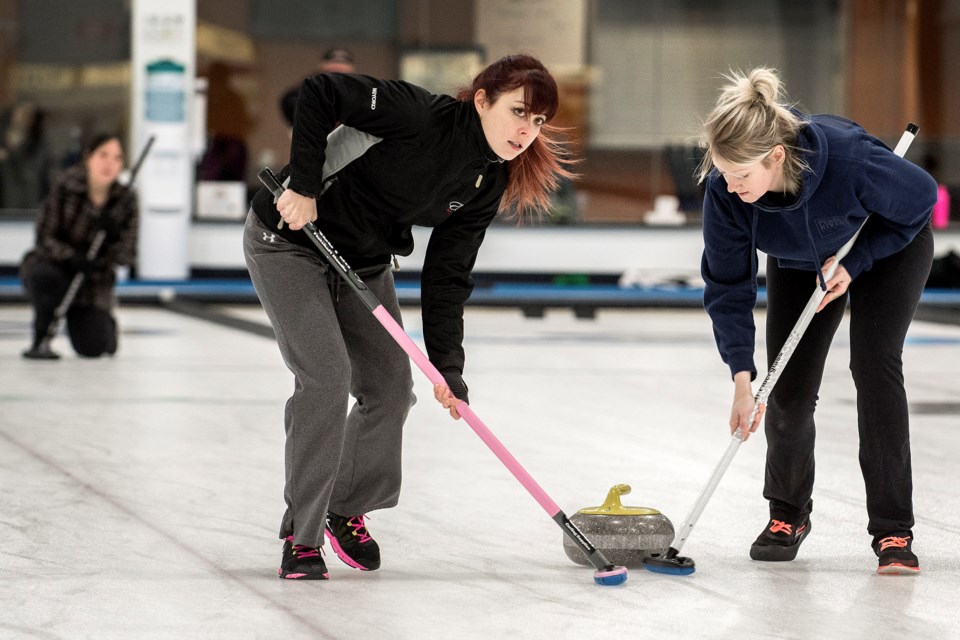 SLIDING ALONG – Miyoko Sawada, left, and Sydney McLellan sweep skip stone as Kimiko Sawada eyes the line during action in the St. Albert Fraternal Order of Eagles' weekly Sunday morning league at St. Albert Curling Club.
DAN RIEDLHUBER/St. Albert Gazette