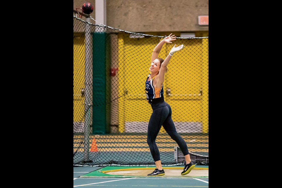RELEASE POINT – Andrea Diener of the St. Albert Mustangs Track and Field Club unleashes the 20-lb. weight throw apparatus at the Last Chance Meet, hosted by Athletics Alberta in November at the ButterDome. Diener, 44, set a Canadian Masters Athletics W40 division indoor record in the weight throw with a personal best of 11.04 metres. 
TIM OSBORNE/Photo