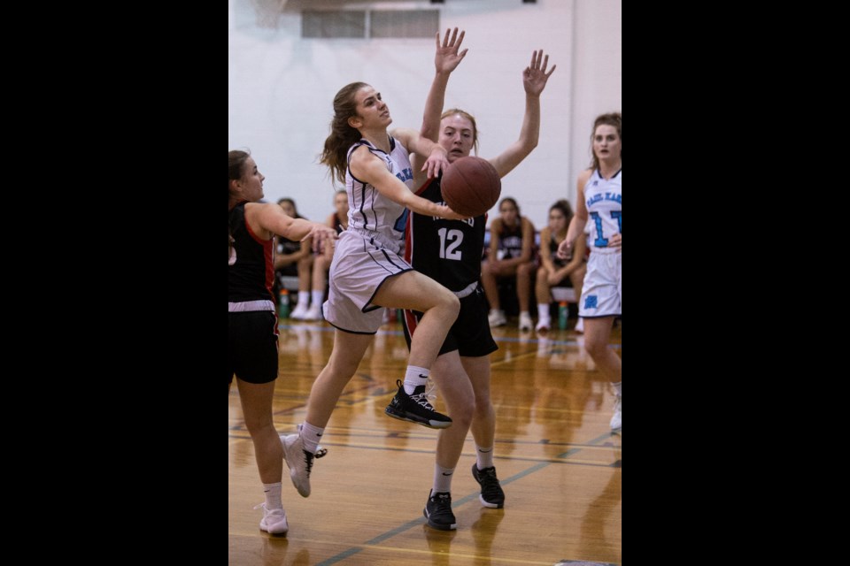 LAYING IT UP – Chelsea Marko of the Paul Kane Blues goes in for the layup against Elise Toogood of the Jasper Place Rebels in Wednesday's metro Edmonton division one season opener for both team. The Rebels won 83-50 at Paul Kane.
