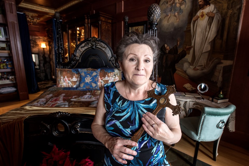 Barbara Ryan in The Royal Queen Isabella Suite of her newly opened Ryans Castle in Sturgeon County. Barbara is holding one of her many relics.  DAN RIEDLHUBER/St. Albert Gazette