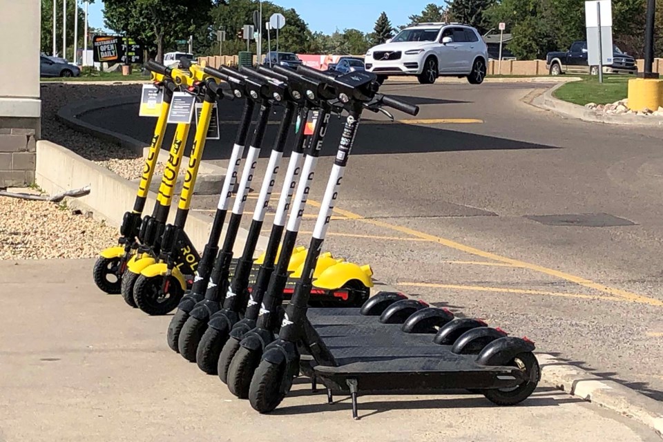 A row of e-scooters is lined up outside the shops at Village Landing on Thursday afternoon, waiting for eager riders to take them out for a spin as part of the city's new pilot, which began Sept. 7. BARB WILLIAMSON/St. Albert Gazette