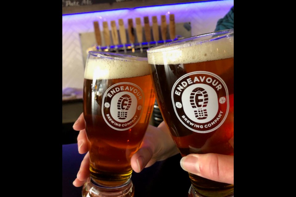 Locals share a craft beer from local brewery Endeavor Brewing Company in St. Albert. 