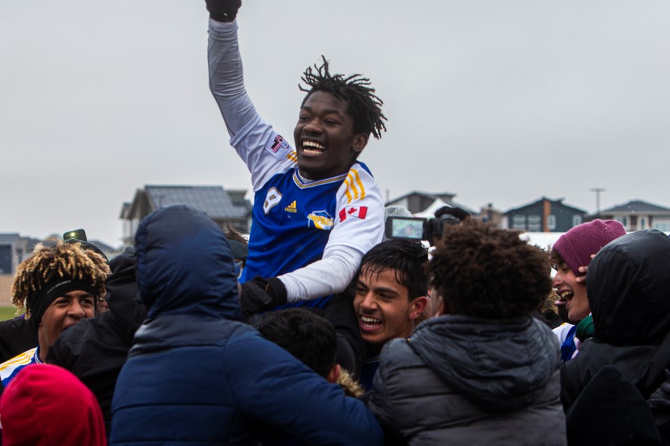 GOLDEN MOMENT – Felix Mutuyemungu of the St. Albert Impact celebrates Monday's 2-1 gold-medal victory over Calgary Foothills FC with teammates and fans at the U15 National Cup. Mutuyemungu's goal in the 57th minute broke a 1-1 tie at at Ivor Dent Sports Park. 
CHRIS COLBOURNE/St. Albert Gazette