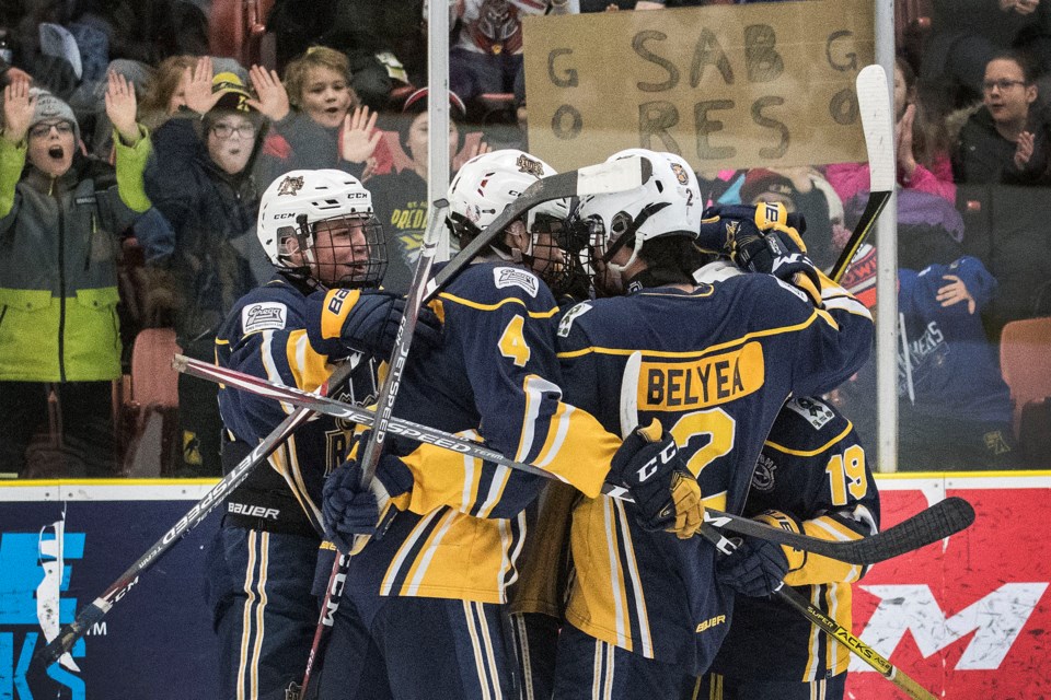 WHOOPING IT UP – Fans and players celebrate the first goal by the St. Albert Gregg Distributors Sabres in the John Reid Memorial Tournament. Evan Zazulak scored 54 seconds into the team's opening game against the Balgonie (Sask.) Prairie Storm at Go Auto Arena and Adam Chin stopped 24 shots in Thursday's 4-0 shutout. The next game was the 6-3 loss to the Los Angeles Jr. Kings. The last game in pool play before today's playoff round was against the St. George’s Saints of Vancouver and Friday's score was unavailable at press time.
DAN RIEDLHUBER/St. Albert Gazette
