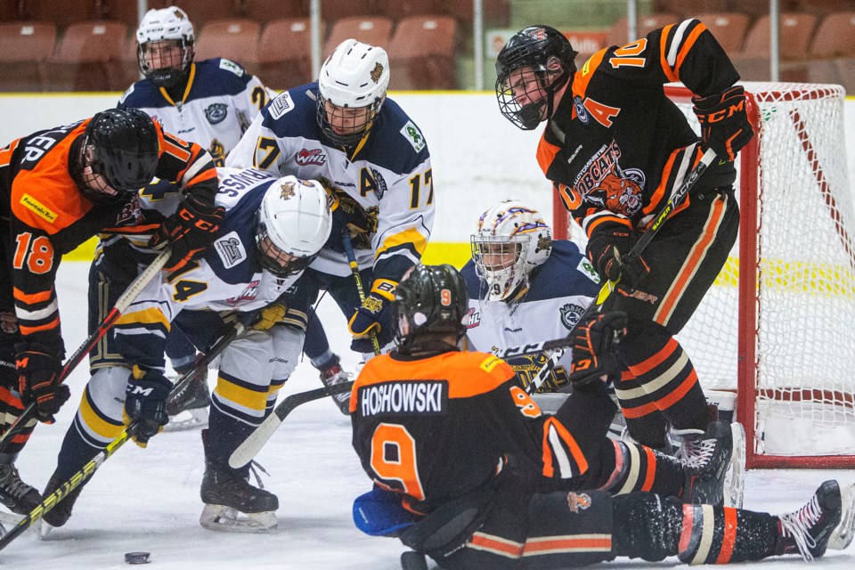 PUCK SCRUM – Adam Chin, netminder for the St. Albert Gregg Distributors Sabres, eyes up the puck along with teammates Kieran Strauss, left, and Johnny Ballos as Kale Tipler, far left, Brent Hoshowski and Ty Bryden of the Lloydminster Bobcats (9-4-6) in the vicinity during action on Raiders Day in St. Albert on Saturday. The Sabres won 2-1 with Carmelo Crandell and Jack Ketsa scored late in the third period at Go Auto Arena. Sunday the Sabres (17-4-1) lost 3-2 against the host Sherwood Park Flyers (9-8-4). The Sabres were 11-0-1 before the loss ended a seven-game winning streak. The next game is 10:45 a.m. Sunday versus the Calgary Royals (11-5-3) at Jarome Iginla Arena. 
CHRIS COLBOURNE/St. Albert Gazette
