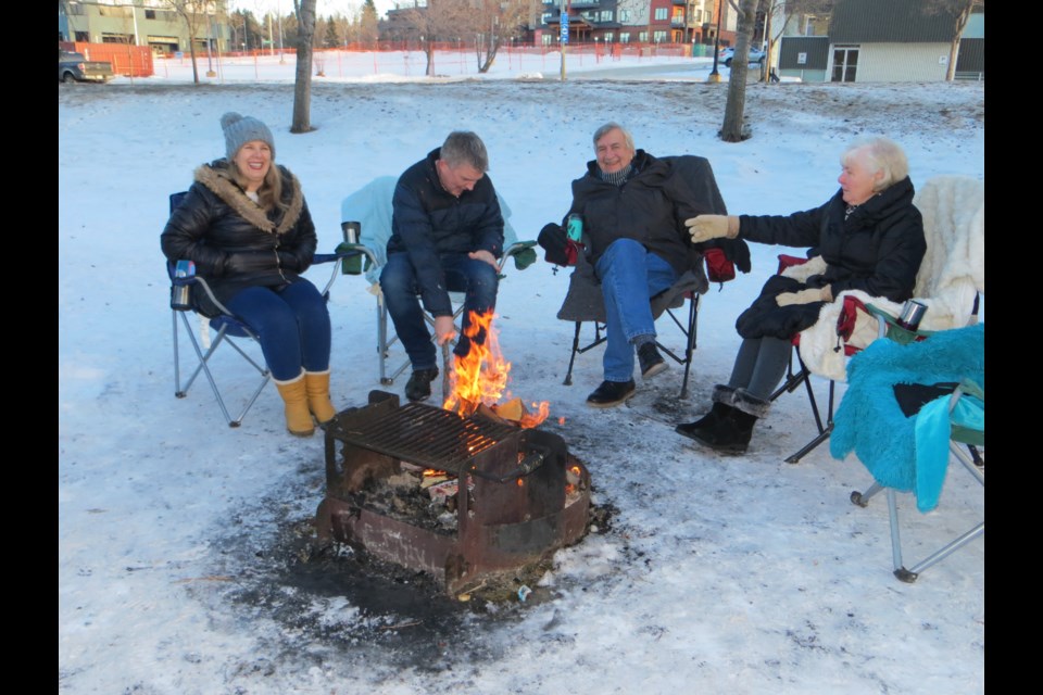 Two generations of Hargreaves enjoy a warm chuckle at Lions Park as a cinder explodes from the fire and lands on Steve's coat sleeve creating a burn hole. From left to right, Amanda, Steve, Peter and Ruth.