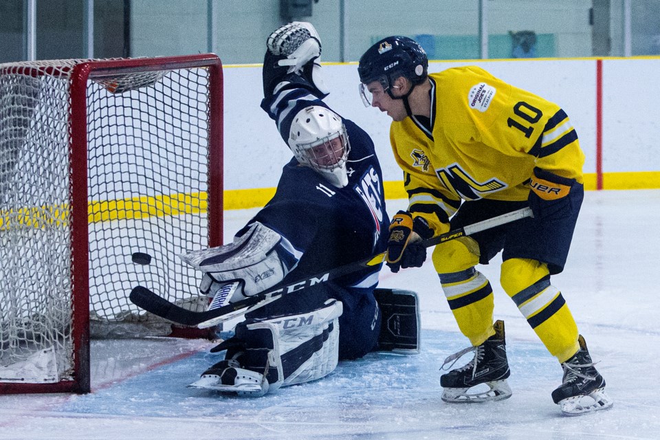 GOAL GETTER – Stuart Dovey of the St. Albert Merchants deposits the puck past Luke Hall of the Morinville Jets in Saturday's junior B game at Morinville Leisure Centre. Dovey potted his team-leading  15th and 16th goals of the season in the opening period of the 7-4 victory. The Merchants (12-5) skate into Friday's home game against the Spruce Grove Regals as winners of seven in a row and 10 of the last 11 games. Puck drop is 8 p.m. at Jarome Iginla Arena. 
CHRIS COLBOURNE/St. Albert Gazette