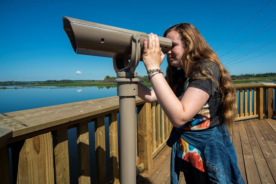 Sarah Keels, 12, of St. Albert checks out the view from the BLESS Platform at Big Lake on Monday. After days of rain, the sun returned and the mercury topped out at 23 C, making for a warm afternoon. CHRIS COLBOURNE/St. Albert Gazette