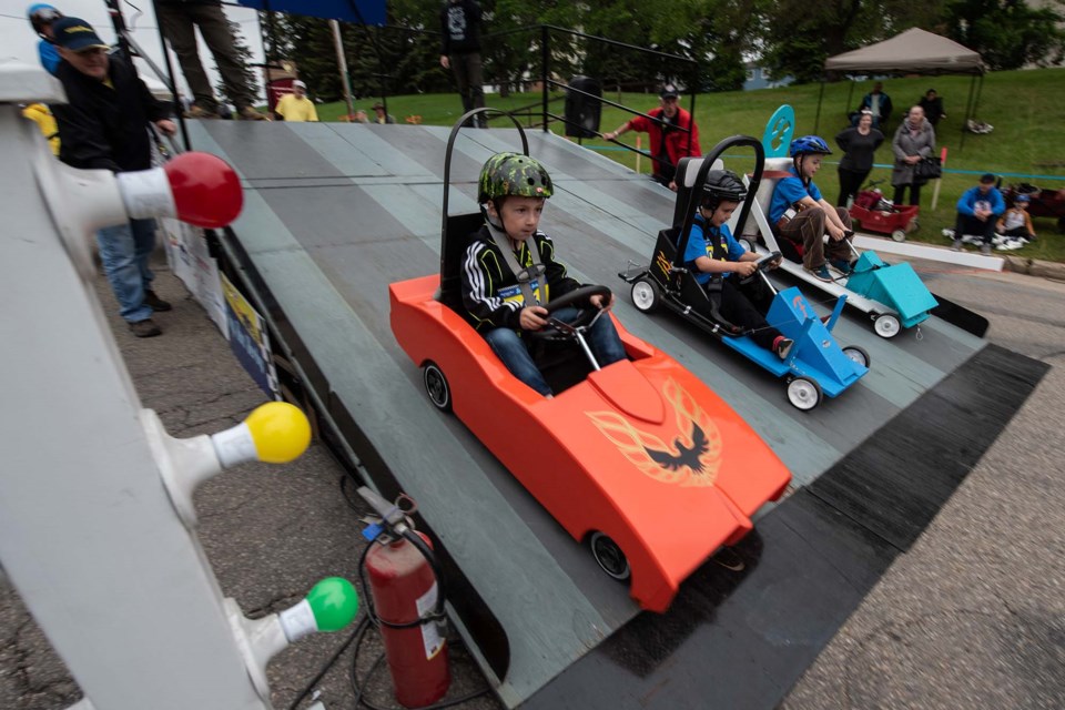 Seven-year-old Sterling Waterhouse launches his bright orange Firebird during the 2022 St. Albert Soap Box Derby down St. Vital Aveue on June 18, 2022. JOHN LUCAS/St. Albert Gazette