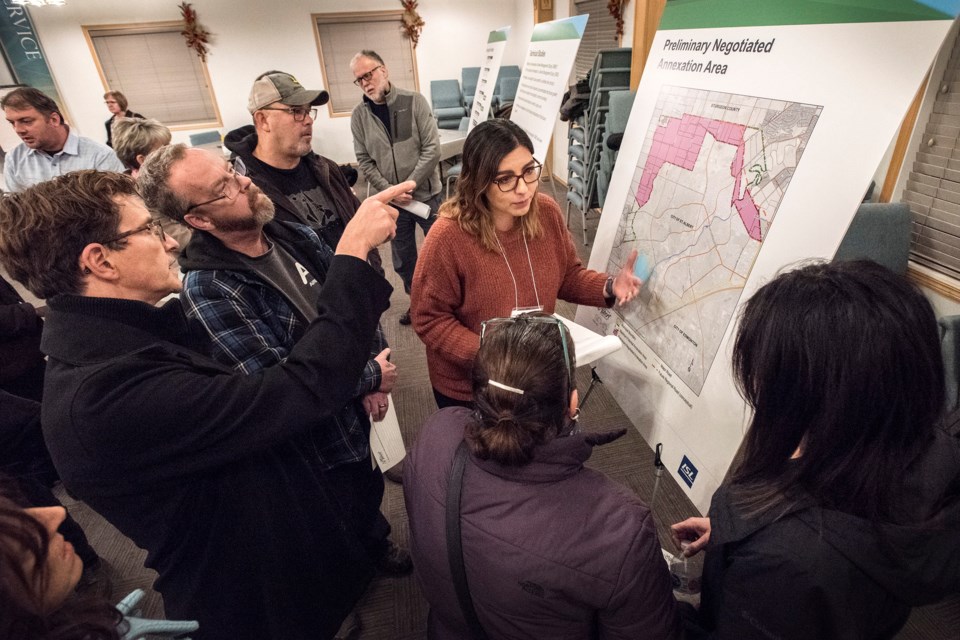 Nathalia Schwind of ISL Engineering facilitates for residents at one of the displays during the St. Albert Annexation Open House at the Christ Community Church in St. Albert November 20, 2019.   DAN RIEDLHUBER/St. Albert Gazette