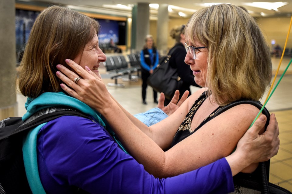 Velvet Martin of St. Albert, right, gazes into her long lost sister Bonnie Williamson-Powell's eyes for the first time at the Edmonton Internaional Airport June 11, 2019. DAN RIEDLHUBER/St. Albert Gazette