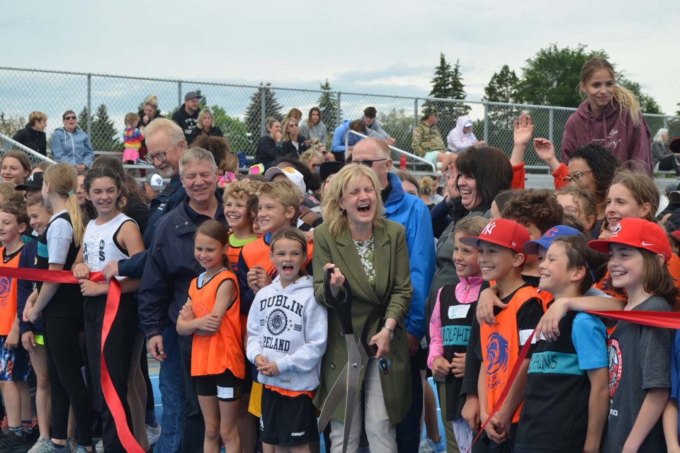 AT THE FINISH LINE — Students, councillors, and city staff participating in the district elementary schools track meet pose for a photo celebrating the completed upgrades to Fowler Athletic Park on Thursday, June 23, 2022. RACHEL NARVEY/St. Albert Gazette