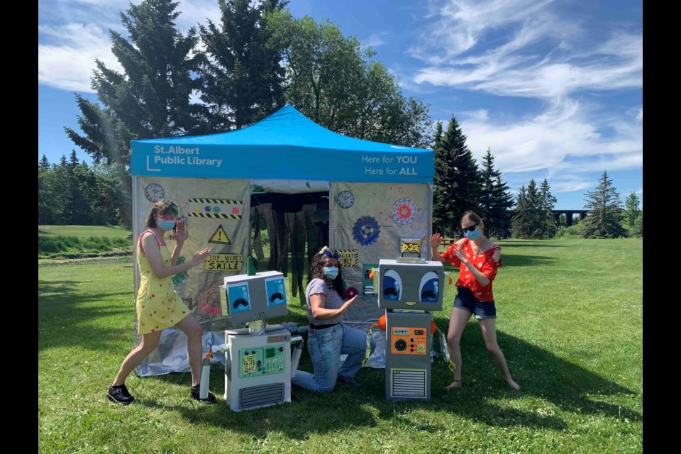 Library game attendants Claire MacMahon, Michailla Barrow, and Gabrielle Kramer are in action mode. The summer reading game returns this week and child readers are tasked with saving the future (and reading lots of great books, too).