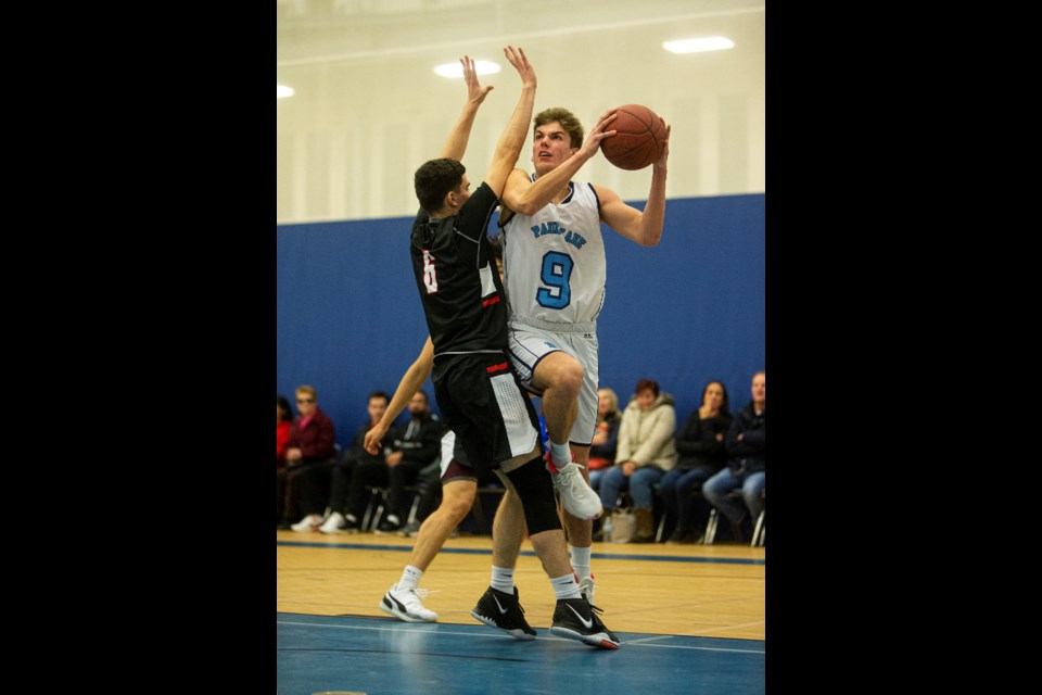 SCORING THREAT – Ryan Holmes of the Paul Kane Blues busts a move against Jayson Del Carmen of the Jasper Place Rebels at the 22nd annual MIke Dea Classic on Thursday at St. Francis Xavier Sports Centre. Holmes scored a team-high 16 points in the 60-53 win to kick off the tournament.
CHRIS COLBOURNE/St. Albert Gazette