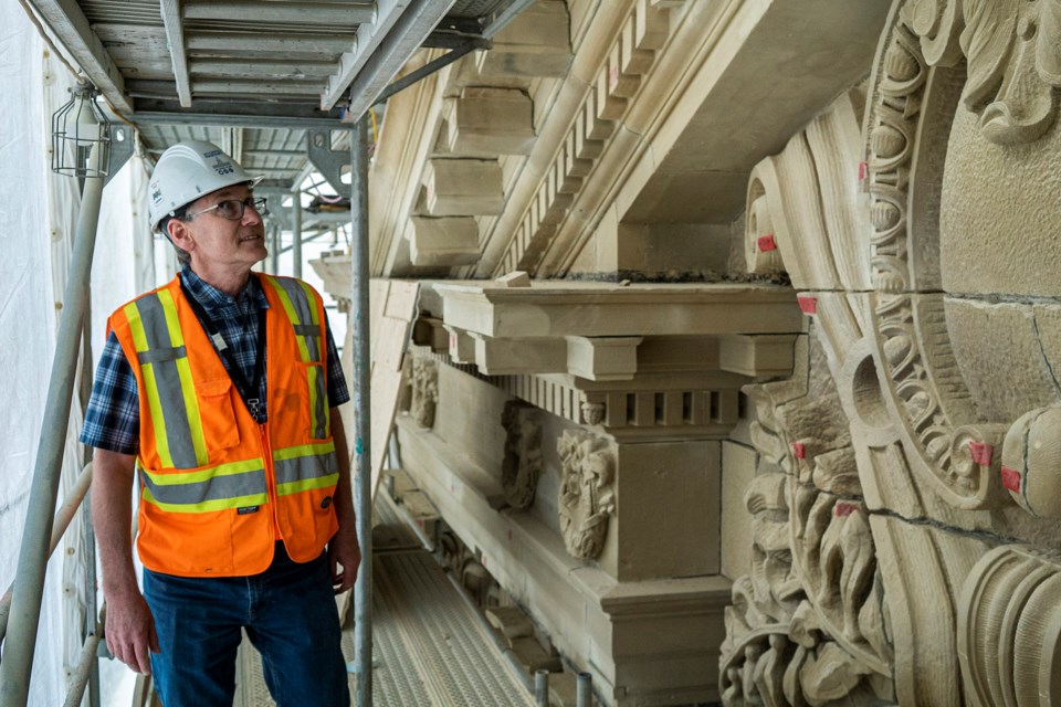 St. Albert's Rob Pacholok of Building Science Engineering inspects a large relief on the southwest side of the Alberta Legislature in mid May as workers perform a massive restoration project on the historic building. CHRIS COLBOURNE/St. Albert Gazette