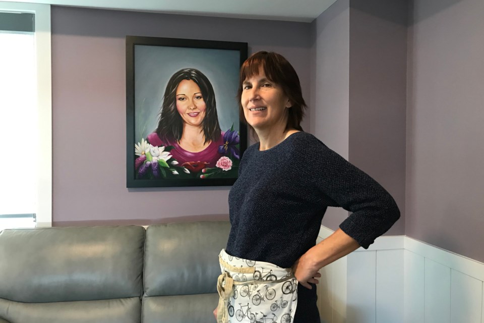 Lynnne Rosychuk stands in front of a portrait of her slain daughter, Jessica Martel, inside Jessie's House. The piece was painted and gifted by Morinville artist Andrea Pautonnier.  Photo submitted 