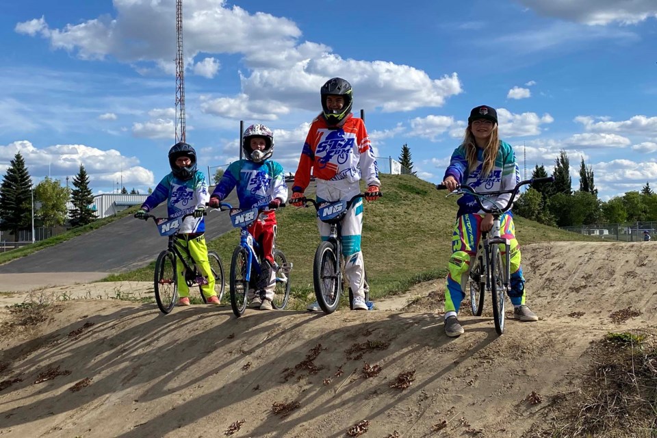 (L-R) Hailyn Walsh, Gretchen Hook, Ariana van Leeuwen, and Aaliyah van Leeuwen pose with their national plates at the St. Albert BMX track on August 29, 2021. PRESTON HODGKINSON/St. Albert Gazette