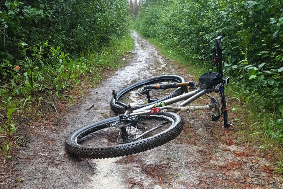 A scene during a break from Dean Anderson's recent Everesting up and down Signal Mountain in Jasper National Park. The muddy mountain bike trail made the experience tougher than usual over his 26-hour ride. 
KRISTIN ANDERSON/Photo