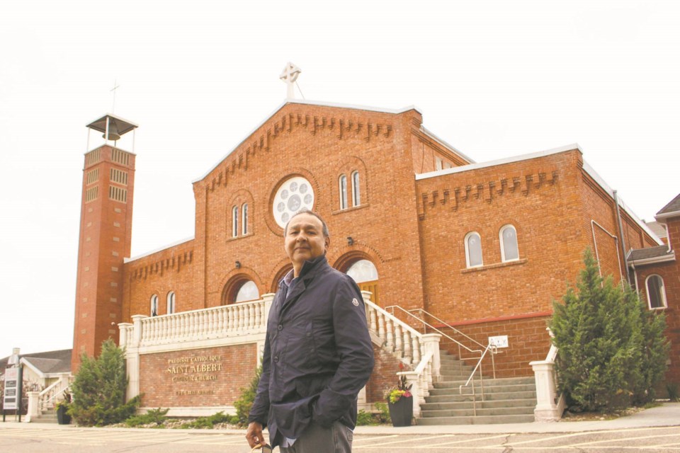 Bruce Gladue stands in front of the St. Albert Catholic Parish where the Metis local will be searching for the unmarked graves of Metis and Indigenous children who were forced to attend the Youville residential school. JENNIFER HENDERSON/St. Albert Gazette

