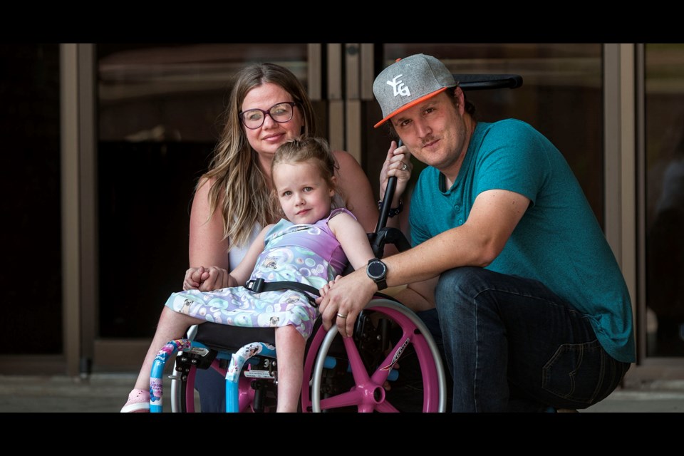Jodi and Lee Richardson with their daughter, four year old Emmy Richardson, outside the back door to the library at St. Albert Place on July 31, 2019, where accessibility is particularly difficult for the family. DAN RIEDLHUBER/St. Albert Gazette