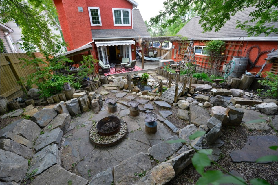 A view from the top of Mark Pesklewis's magnificent backyard, a space that he lovingly and patiently created with lots of found rocks and vintage antiques found on the cheap at thrift shops.