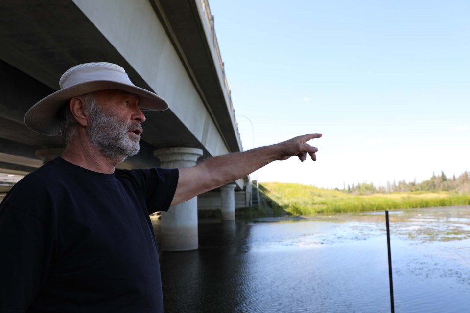 Dave Burkhart, Big Lake Environmental Support Society (BLESS) member shows the Gazette where he initially saw dead fish near the Ray Gibbon Drive bridge construction site. JESSICA NELSON/St. Albert Gazette