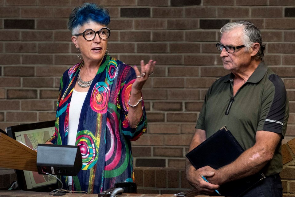 Esther Kupsch gestures to supporters of the Erin Ridge issue in the gallery during her speech at a city council meeting in St. Albert on Monday, Aug. 12, 2019. Co-speaker, Grant Letendre, stands behind her at the podium. DAN RIEDLHUBER/St. Albert Gazette