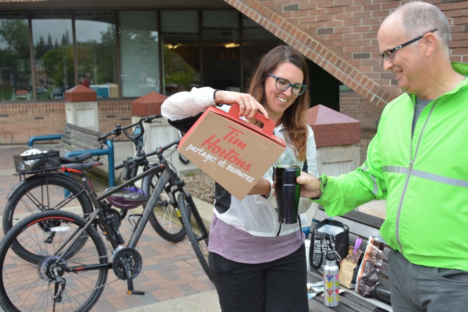 Christina Herbers and Robert Doyle take in the three C's – coffee and conversation and cycling – during a recent YEGBike meetup. The group plans ahead to bike to a gathering place where they stop for some hot coffee and camaraderie that can only come with a community of two-wheeler enthusiasts. SCOTT HAYES/Photo