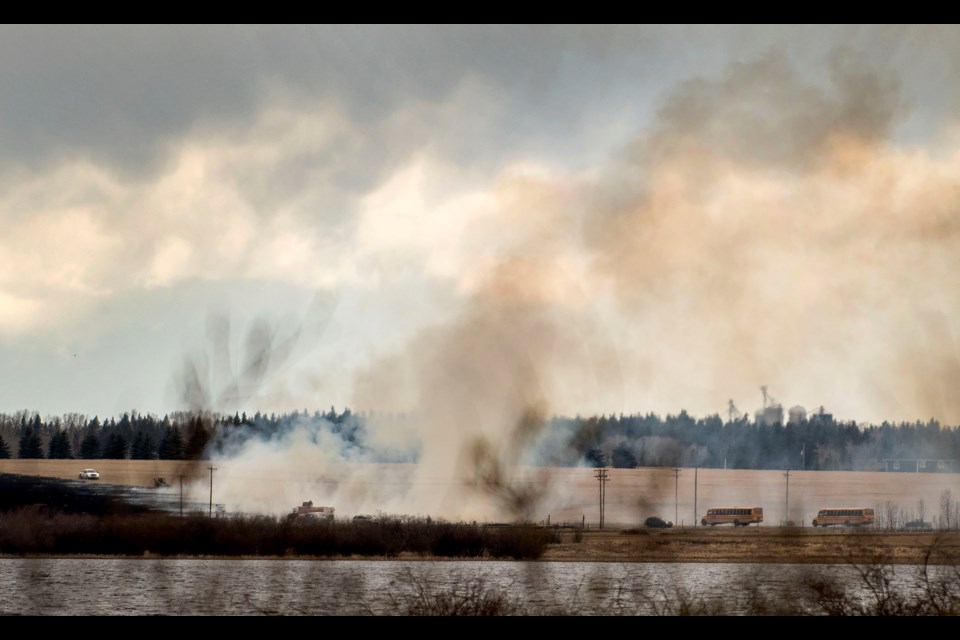 Smoke rises from a brush fire south of Meadowview Dr. and west of Ray Gibbon Dr. as seen from Lois Hole Park's parking lot April 17, 2019. DAN RIEDLHUBER/St. Albert Gazette