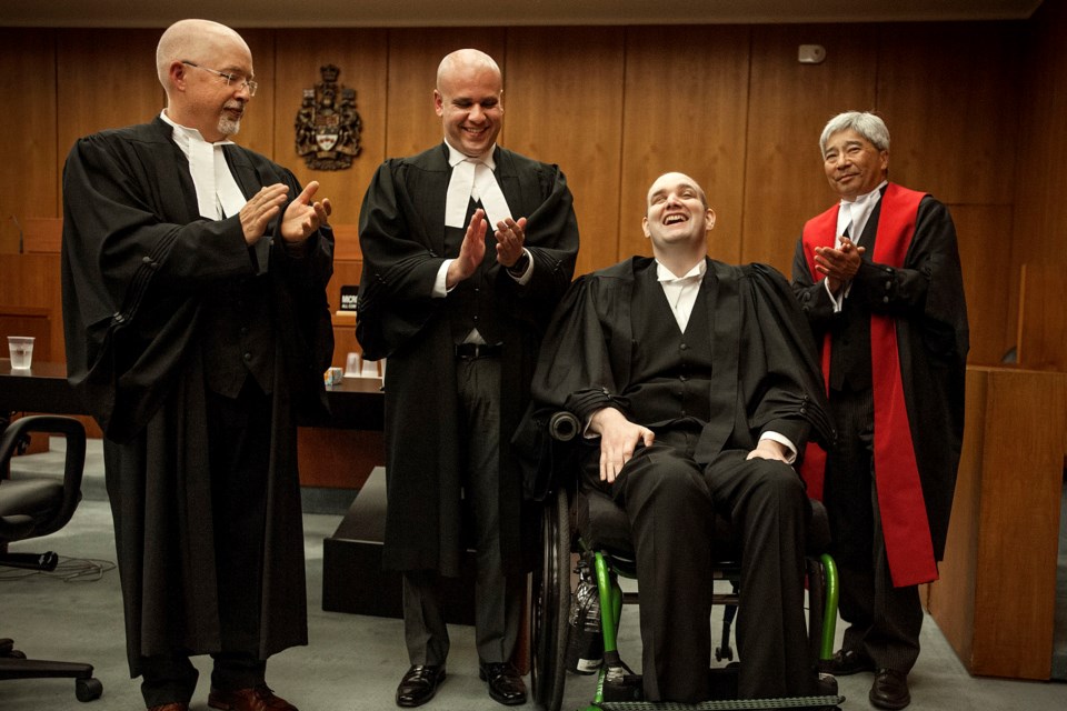 Wade Brown is gleeful after being called to the bar on Friday. He was joined in the ceremony by his presenting lawyer, Andrew Geisterfer, left, associate lawyer Adam Zibdawi and Court of Queens Bench Justice Douglas Mah. DAN RIEDLHUBER/St. Albert Gazette