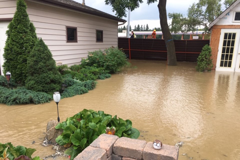 Some homeowners living along the St. Albert Trail barrier wall continue to deal with repercussions of a broken water main during replacement work of the barrier wall July 30. Yards, garages and basements were flooded after 1,000 cubic metres gushed out. GREG SPARKE/Photo